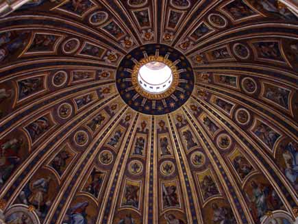 Looking up inside the dome of Saint Peter's Basilica showing the ornate painted frescos. Around the bottom of the dome is the Latin legend Tu es Petrus... (You are Peter and on this rock I will build my church)