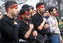 Muslim men wearing red headbands in the Ashura procession