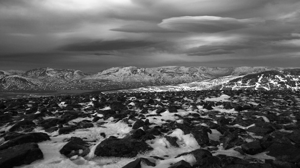 Lenticular clouds above snow dusted peaks