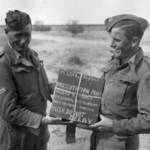 22/3/1943 Sid Edwards (right)hands over the film of 'Desert Victory' to be flown back to Britain