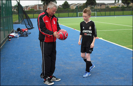 Coach Anthony Pringle coaches another youngster
