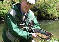 Tony Bridgett and a wild brown trout caught in the River Dove