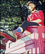Kid Acne sat on a telephone box
