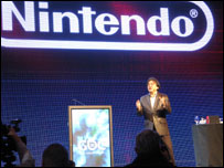 Surato Iwata in front of Nintendo screen