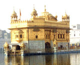 The Golden Temple, a gold-coloured building on the waterfront