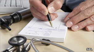 Gp writing prescription next to stethoscope