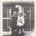 A photo taken of my father Bill Pope and me Douglas Pope in his arms. I think I am around one years old in this photo and this is the first time I remember meeting my father who was home from the army on leave. It was taken at the back of our house in Rushden, Northamptonshire.