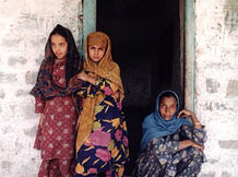 Family of Indian women in traditional clothing standing in a doorway