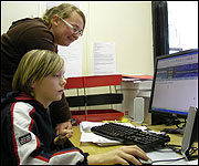 Natalie helping Ryan with IT skills