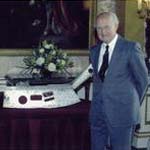 A Picture of the Queen and myself, with the 1 metre long piece of the aircraft, from which I fell. It was presented to me at Buckingham Palace.