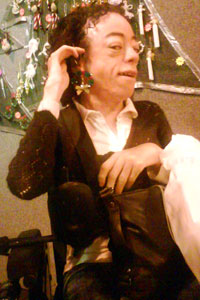 Do you think they're me, darling? Liz tries on some earrings at the Christmas craft fair