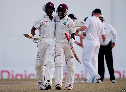 Daren Powell and Fidel Edwards celebrate after drawing the third Test