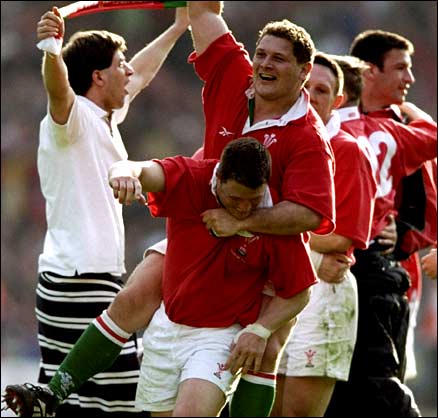 Scott Gibbs is mobbed after dancing over for a famous Wales win in 1999
