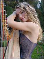 woman leaning against harp