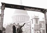 Photograph showing a bombed building in the shadow of St Paul's Cathedral, London
