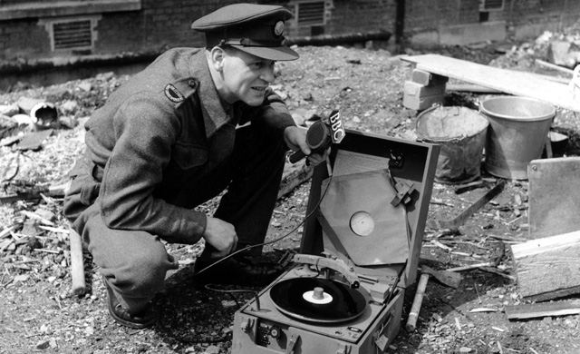 CD Adamson, engineer correspondent of the BBC War Reporting Unit, with a midget recorder of the type used in World War II and developed by the BBC for front-line reporting
