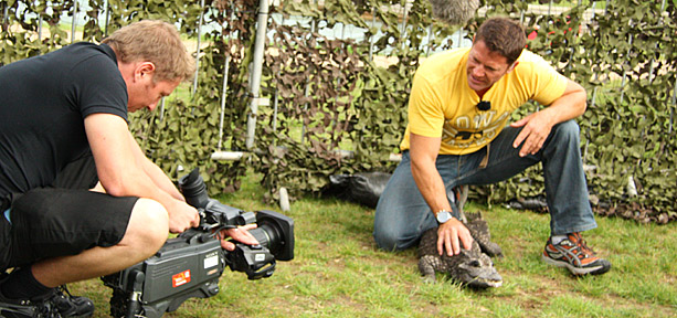 Steve Backshall holding a croc whilst being filmed
