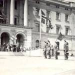 This is the King of Norway Hakan on his return from exile in England. Taking salute at the march past in Oslo in front of the royal palace the royal palace.