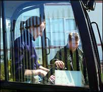 Mark teaching Suzanne how to use the mini JCB