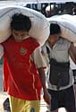 Workers unload rice sacks in Burma 