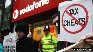 UK Uncut anti-tax avoidance protesters outside a Vodafone store in Birmingham on 4th December 2010