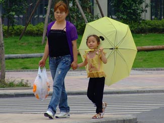 A young girl with an umbrella.