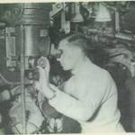 THis is a picture of King George VI on board HMS during WW2. CPO William George Barnett is in the background.