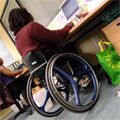 A wheelchair user working in the office