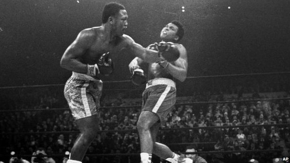 Joe Frazier hits Muhammad Ali with a left during the 15th round of their heavyweight title fight at New York's Madison Square Garden on March 8, 1971