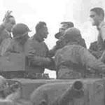 The first American tank on the Akerstraat, Treebeek on 17 Sept. 1944, Brother jaap is waving. Seen here with our friend Adje Paulen.