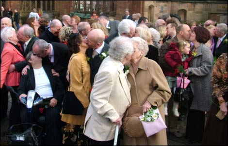 Our couples share a kiss in the Cathedral