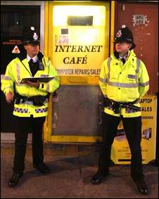 British Police officers outside an internet cafe after a counter-terror operation in Manchester
