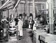 Black and white photograph showing the interior of a confectionery factory