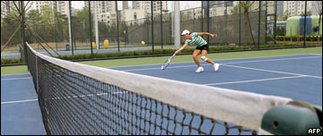 A man plays tennis