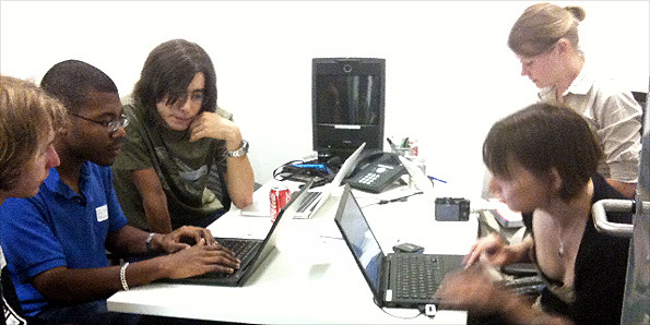 People on computers at Young Rewired State event