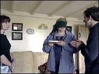 Patricia blindfolded holding the diary