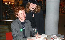Pic: Chris Rankin signs a book.