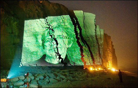 Charlie Morrissey's art projected onto East Cliff, West Bay (photo Pete Millson)