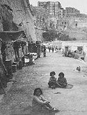 Makeshift homes in the rock face on the outskirts of Valetta