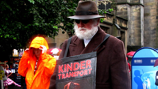 Promoting the show 'Kinder Transport' in the rain